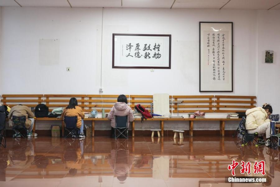 資料圖：幾位考研學(xué)生在南昌大學(xué)教學(xué)樓的公共空間復(fù)習(xí)備考。劉力鑫 攝